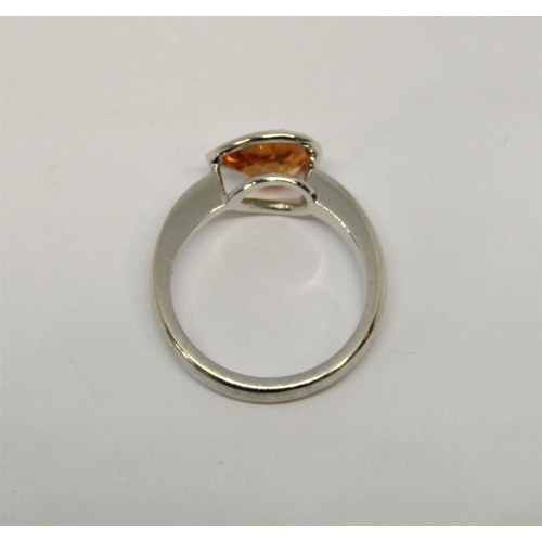 1384 - Pear cut orange garnet ring in unmarked white metal, tests as 18ct white gold, size N, 5.8g