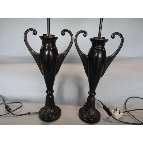 1601 - A pair of lacquered bronzed twin handled baluster vase lamps, upon darted leaf plateau bases, 60cm h... 