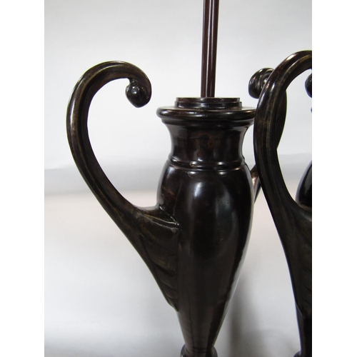 1601 - A pair of lacquered bronzed twin handled baluster vase lamps, upon darted leaf plateau bases, 60cm h... 