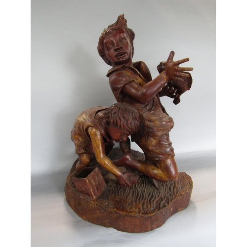 1621 - Possibly Italian carved softwood figure of two boys catching fish, 50cm high