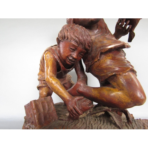 1621 - Possibly Italian carved softwood figure of two boys catching fish, 50cm high