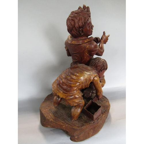 1621 - Possibly Italian carved softwood figure of two boys catching fish, 50cm high