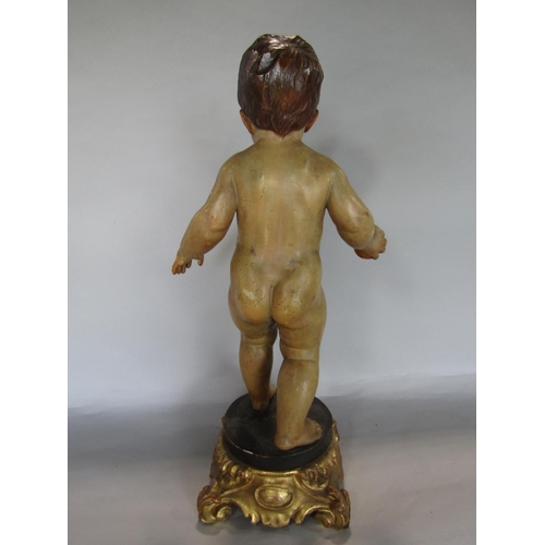 1622 - Good quality probably Italian carved softwood figure of a nude boy holding a ball upon a black plint... 