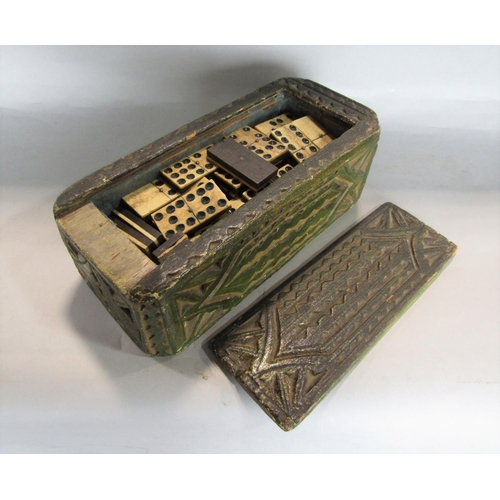 1634 - 18th century carved pine games or candle box, with naive carved panels, the slide top enclosing a co... 