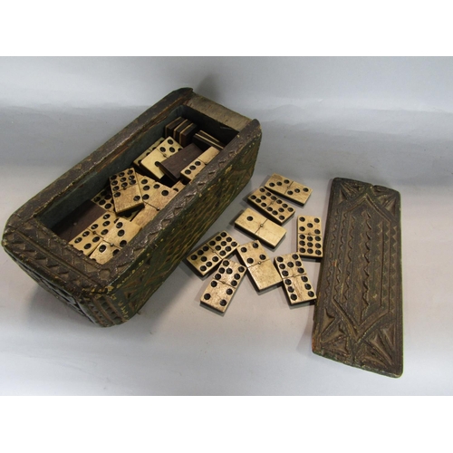 1634 - 18th century carved pine games or candle box, with naive carved panels, the slide top enclosing a co... 