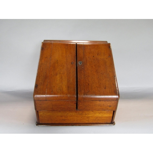 1635 - Early 20th century golden oak desk top box, the sloped top enclosing a waterfall interior and recess... 