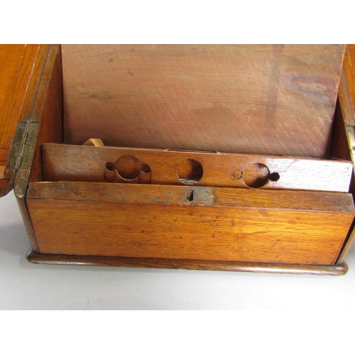 1635 - Early 20th century golden oak desk top box, the sloped top enclosing a waterfall interior and recess... 