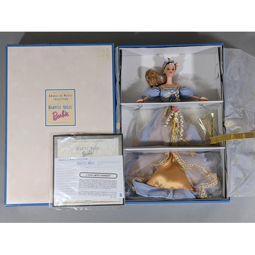 123 - 4 boxed themed Barbie dolls including  'Harpist Angel', 'Golden Anniversary 1945-1995', 'Barbie as t... 