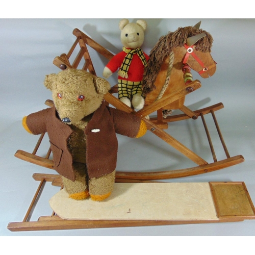 144 - Vintage wooden rocking horse, length 84cm, together with a toy ironing board, knitted Rupert bear an... 