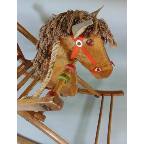 144 - Vintage wooden rocking horse, length 84cm, together with a toy ironing board, knitted Rupert bear an... 