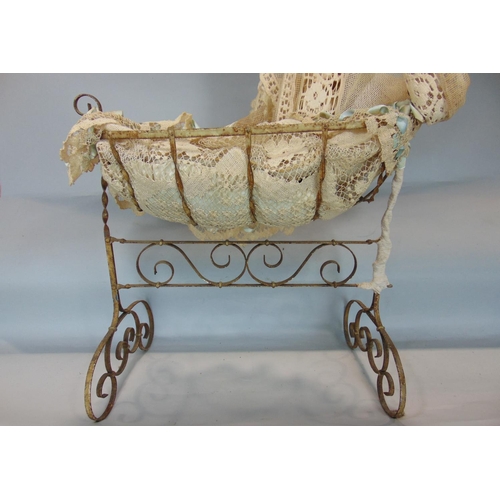 145 - Vintage dolls metal rocking crib with lace drapes  and cushioning, height 90cm