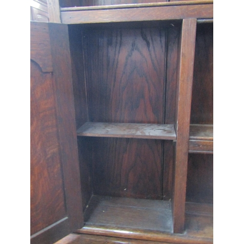 2347 - A Georgian revival oak dresser, the base enclosed by three fielded arched panelled doors and three f... 