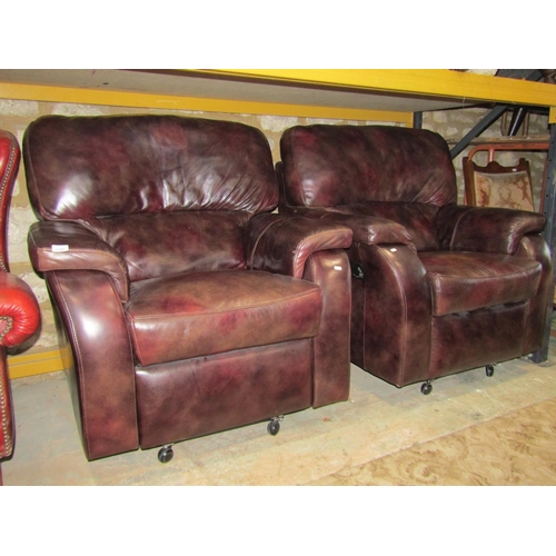 2319 - A pair of contemporary stitched brown leather reclining armchairs with soft pad arm cushions