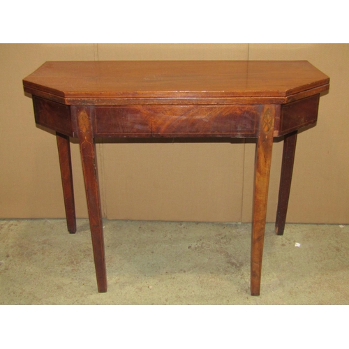 2350 - A Georgian mahogany foldover top breakfront tea table with inlaid detail, canted front corners and s... 