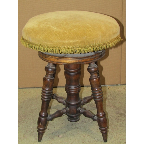 2352 - An Edwardian stained beechwood piano/music stool with circular upholstered revolving adjustable seat... 