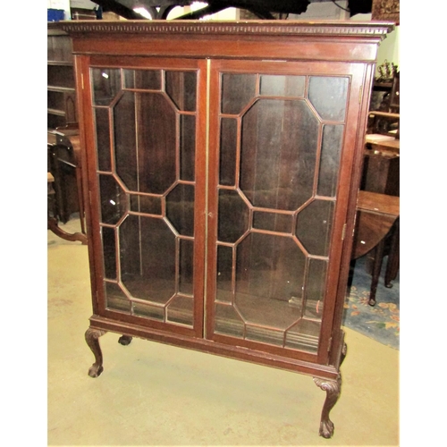 2354 - A Georgian revival side cabinet with dentil moulded cornice over a pair of rectangular astragal glaz... 