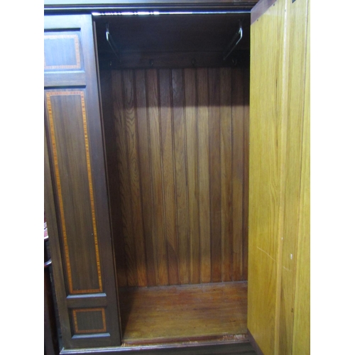 2356 - An inlaid Edwardian walnut wardrobe with satinwood crossbanding and moulded cornice over a central t... 