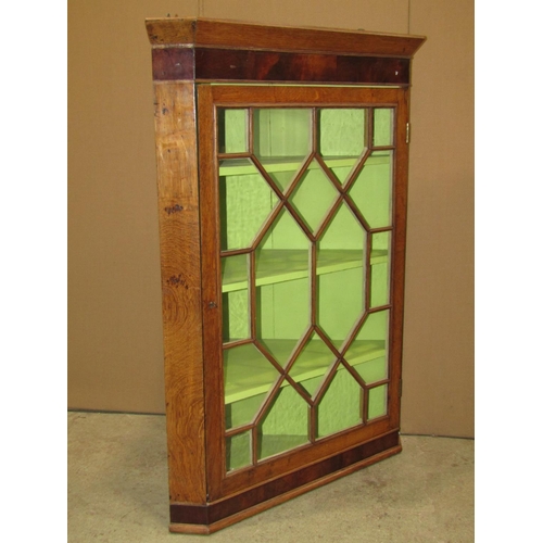 2359 - A 19th century oak hanging corner cabinet enclosed by a rectangular astragal glazed panelled door re... 