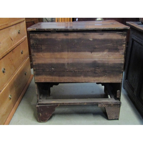 2364 - A Georgian mahogany commode in the form of a mock four drawer chest with rising lid and bracket supp... 