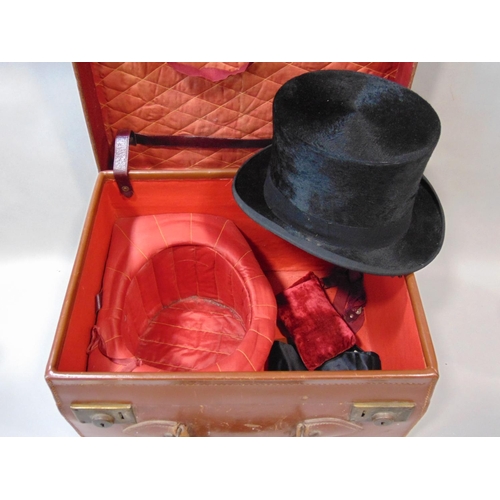 1556 - Leather travelling case fitted for carrying top hat and accessories, containing black silk top hat, ... 