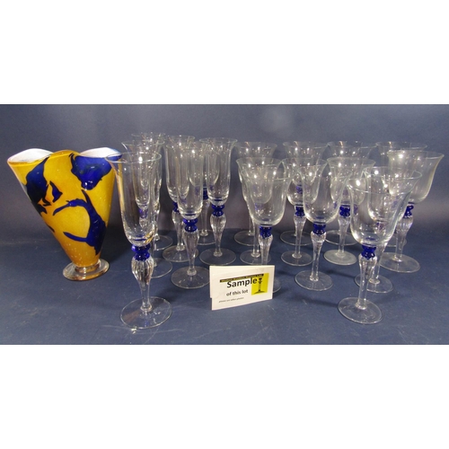 1148 - A large collection of stylish glass goblets with fluted baluster stems and blue band, to include lar... 