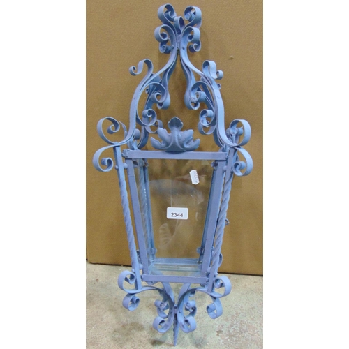 2424 - A hall or porch lantern of square tapered form the decorative painted ironwork frame with scroll det... 