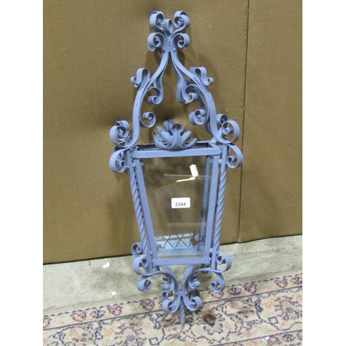 2424 - A hall or porch lantern of square tapered form the decorative painted ironwork frame with scroll det... 