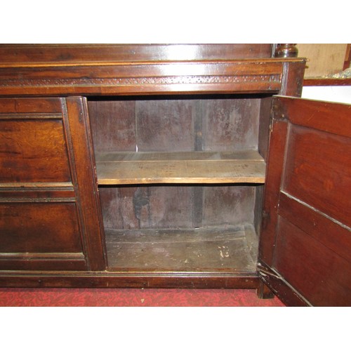 2423 - An 18th century oak court cupboard enclosed by an arrangement of four moulded rectangular panelled d... 