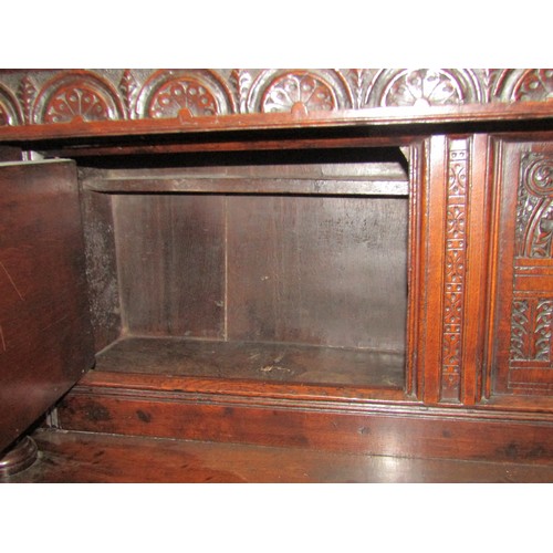 2423 - An 18th century oak court cupboard enclosed by an arrangement of four moulded rectangular panelled d... 