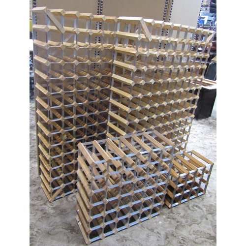 2168 - A pair of contemporary wine racks with pine and galvanised steel strap work construction, each to ho... 