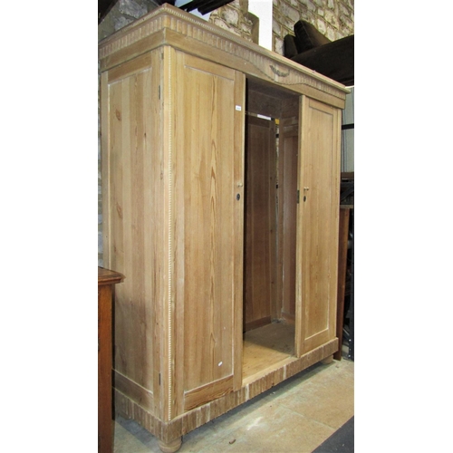 2172 - A continental stripped pine knockdown triple wardrobe, originally enclosed by three full length rect... 