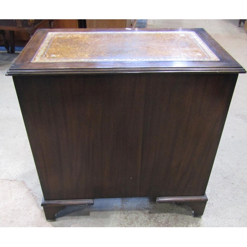 2174 - A reproduction Georgian style mahogany kneehole desk with inset leather panelled top over an arrange... 