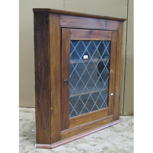 2186 - A reclaimed stained pine hanging corner cabinet enclosed by a rectangular leaded light panelled door... 