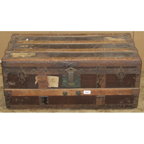 2192 - Two vintage wooden lathe bound and steel banded travelling trunks of varying size, the smaller with ... 