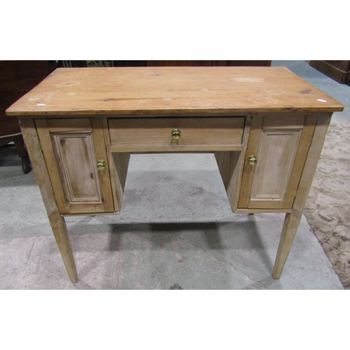 2200 - A rustic stripped pine kneehole side or dressing table fitted with a central frieze drawer flanked b... 