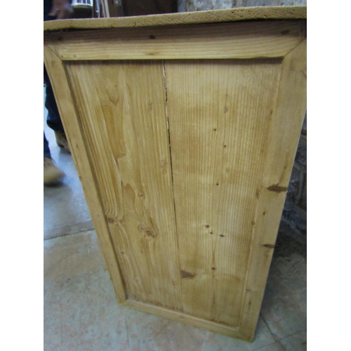 2201 - A pair of low stripped pine side cupboards, each enclosed by a square moulded panelled door beneath ... 