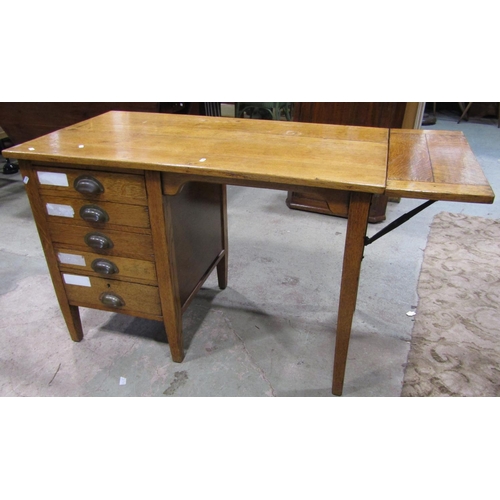 2202 - A vintage oak kneehole single pedestal desk, fitted with four long drawers and drop leaf, raised on ... 