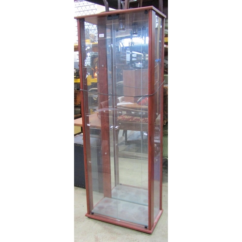 2207 - A contemporary floorstanding display cabinet with glazed surround, enclosed by a pair of full length... 