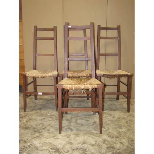 2219 - A set of four arts and crafts style stained beechwood light weight occasional chairs with rush seats... 