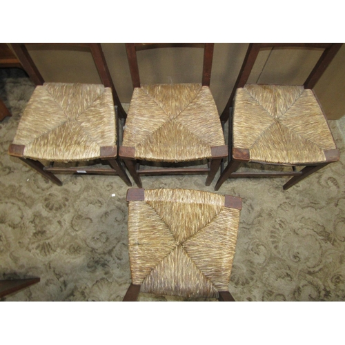 2219 - A set of four arts and crafts style stained beechwood light weight occasional chairs with rush seats... 