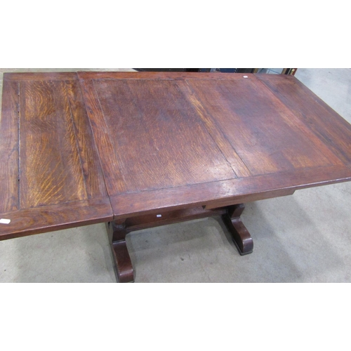 2221 - An oak drawleaf dining table of rectangular form, raised on turned column supports and sledge feet, ... 