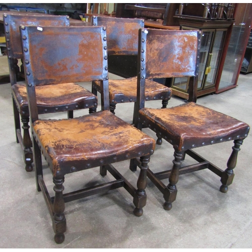 2222 - A set of four Cromwellian style oak framed dining chairs, with studded worn leather upholstered seat... 