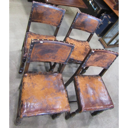 2222 - A set of four Cromwellian style oak framed dining chairs, with studded worn leather upholstered seat... 