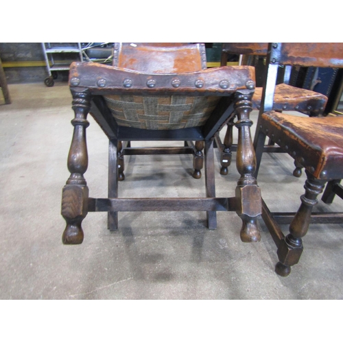 2222 - A set of four Cromwellian style oak framed dining chairs, with studded worn leather upholstered seat... 