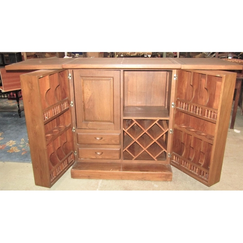 2225 - A contemporary hardwood drinks cabinet and combined bar with panelled frame, foldover top and enclos... 