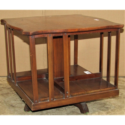 2226 - A small Edwardian walnut table top revolving bookcase of square form with open slatted sections, the... 