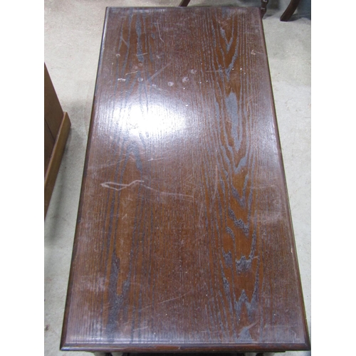 2228 - A Jaycee dark stained oak nest of occasional tables, with carved frieze, raised on turned supports u... 