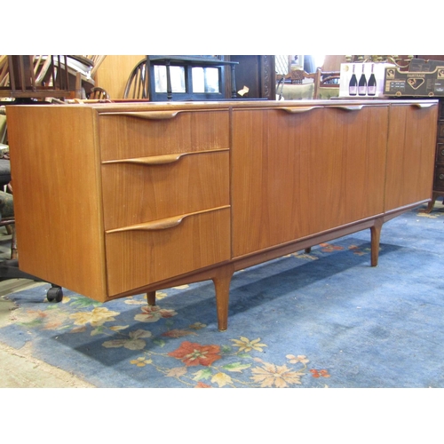 2243 - A long and low teak sideboard by AH Mackintosh & Co Ltd, Kirkcaldy, Scotland fitted and enclosed by ... 