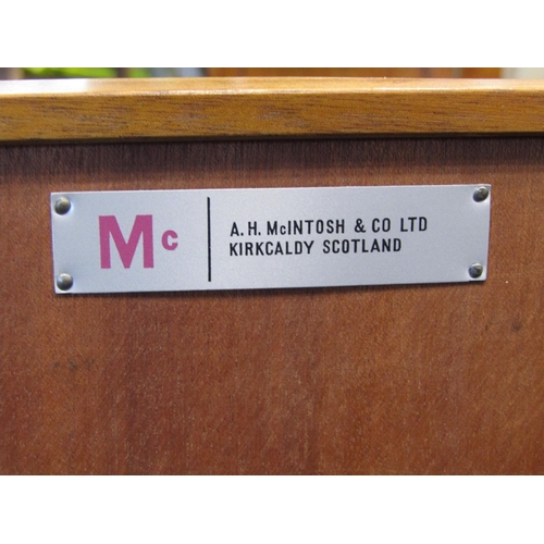 2243 - A long and low teak sideboard by AH Mackintosh & Co Ltd, Kirkcaldy, Scotland fitted and enclosed by ... 