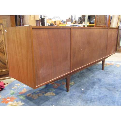 2243 - A long and low teak sideboard by AH Mackintosh & Co Ltd, Kirkcaldy, Scotland fitted and enclosed by ... 